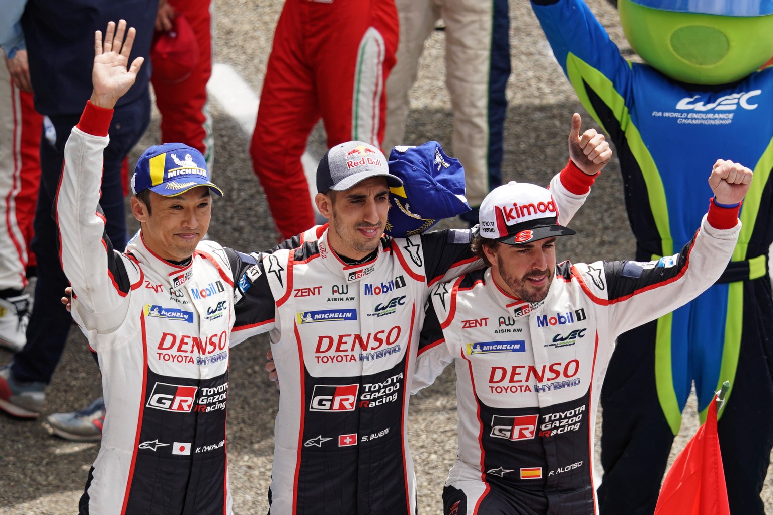 epa07652049 Sebastien Buemi of Switzerland, Kazuki Nakajima of Japan and Fernando Alonso of Spain, drivers of Toyota Gazoo Racing (starting no.8) in a Toyota TS050 Hybrid celebrate after winning the L ...