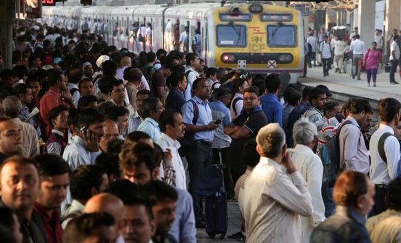 epa05764100 Commuters wait to board a local train in Mumbai, India, 01 February 2017. Indian Finance Minister Arun Jaitley presented the Union Budget 2017 in New Delhi and for the first time the Railw ...