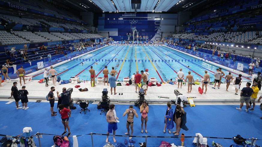 Athletes exercise during a swimming training session at the Tokyo Aquatics Centre at the 2020 Summer Olympics, Friday, July 23, 2021, in Tokyo, Japan. (AP Photo/Martin Meissner)