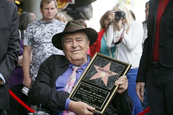 FILE -- in this Nov. 19, 2013 file photo, Italian director Bernardo Bertolucci holds a star plaque at a ceremony in his honor as he makes a rare visit to his star on the Hollywood Walk of Fame, in Los ...
