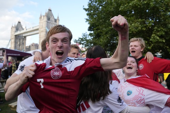 Danish fans celebrate after watching the Euro 2020 quarterfinal soccer championship match between Czech Republic and Denmark being played in Baku, Azerbaijan, at a fan zone in Potters field, London, S ...