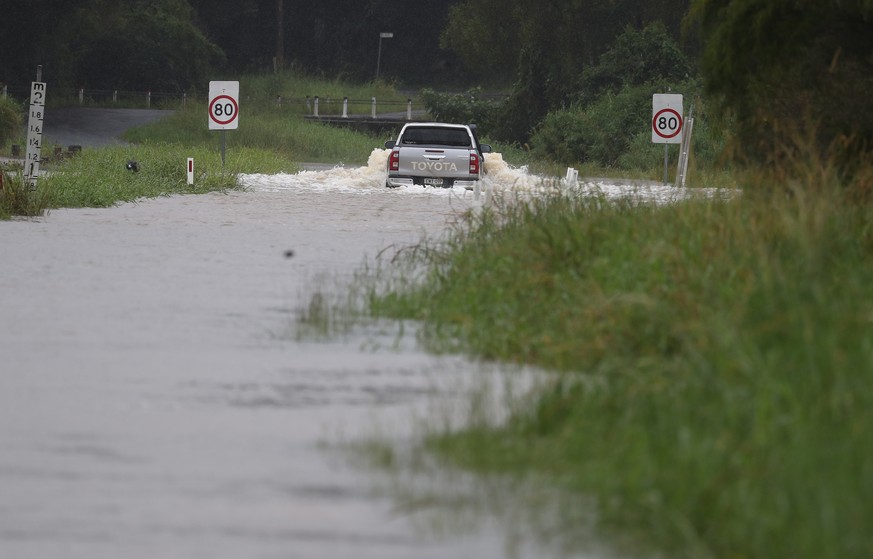 epa09089179 A flooded street is seen in Billinudgel, Australia, 22 March 2021. Thousands of people have been evacuated on the NSW Mid-North Coast and western Sydney, as swollen rivers flood towns and ...