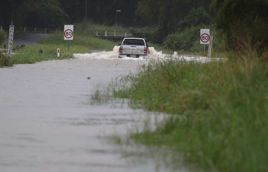 epa09089179 A flooded street is seen in Billinudgel, Australia, 22 March 2021. Thousands of people have been evacuated on the NSW Mid-North Coast and western Sydney, as swollen rivers flood towns and  ...