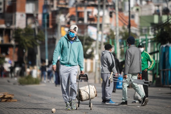 epa08452734 A man with face mask walks during a day of the mandatory quarantine, due to the coronavirus pandemic, at Villa 31 neighborhood in Buenos Aires, Argentina, 29 May 2020. EPA/JUAN IGNACIO RON ...