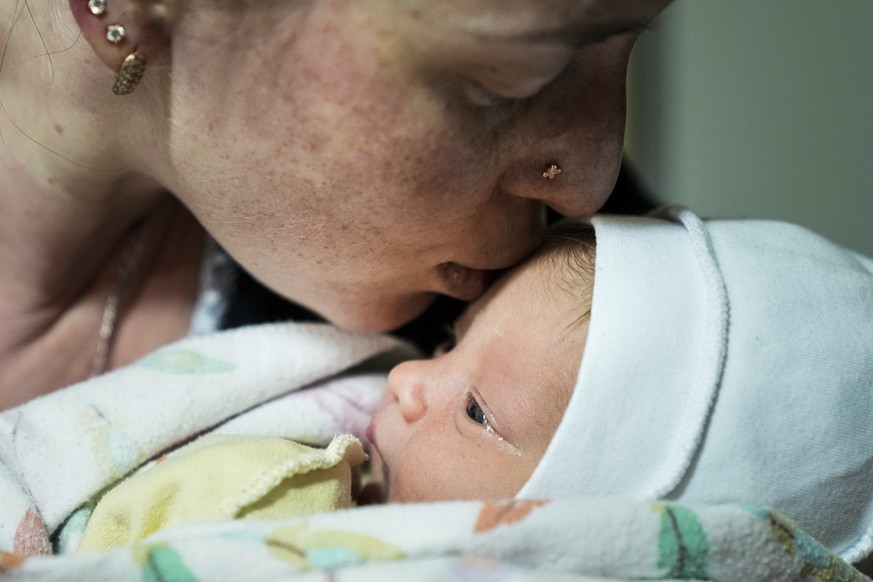 Kateryna Suharokova kisses her newborn son Makar in the basement of a maternity hospital converted into a medical ward and used as a bomb shelter in Mariupol, Ukraine, Monday, Feb. 28, 2022. In makesh ...