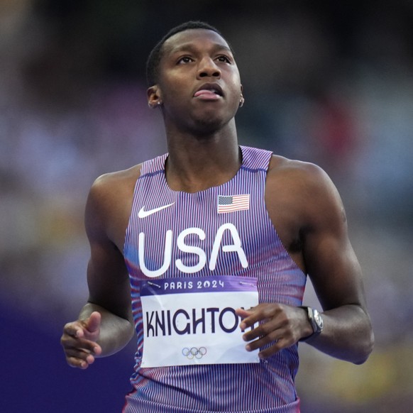 Erriyon Knighton, of the United States, reacts after competing in a men&#039;s 200-meters&#039; heat at the 2024 Summer Olympics, Monday, Aug. 5, 2024, in Saint-Denis, France. (AP Photo/Petr David Jos ...