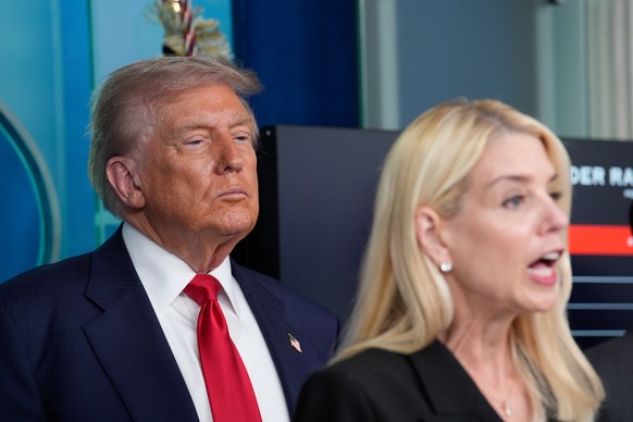 epa12293969 US President Donald Trump (L) listens as US Attorney General Pam Bondi delivers remarks during a press conference in the James S. Brady Press Briefing Room of the White House, in Washingto ...