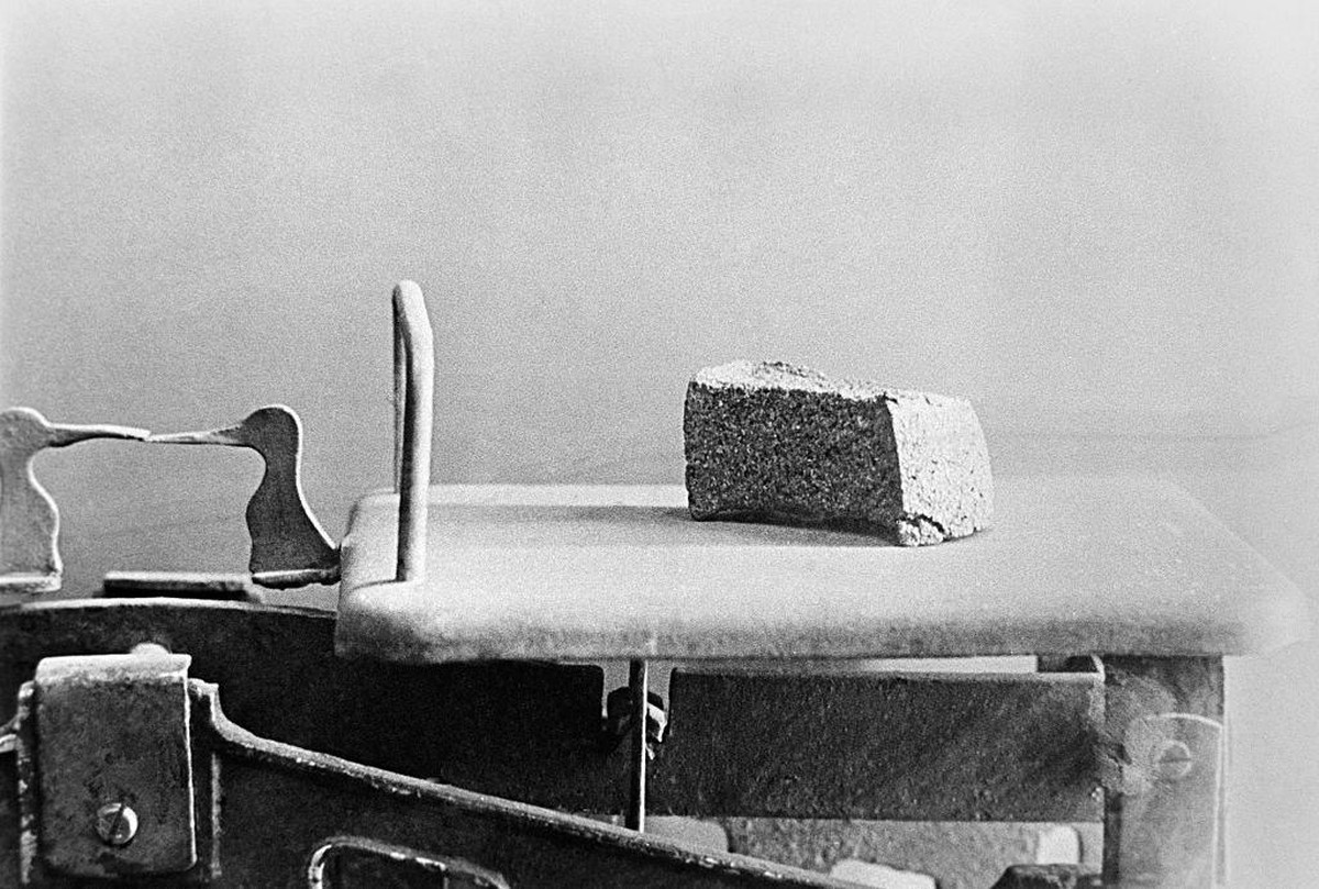 125 Gramm Brot auf einer Wage, die tägliche Höchstmenge, die zu dieser Zeit an die Arbeiter vergeben wurde. Für Zivilisten und Kinder war es noch weniger.