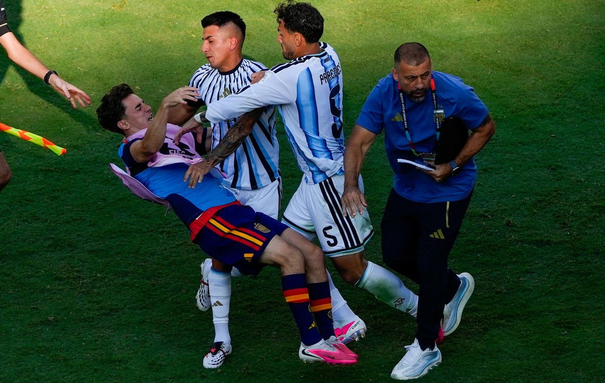 Spain's Gavi, left, falls as he scuffles with Argentina's Leandro Paredes (5) and Thiago Almada during the World Cup final soccer match between Spain and Argentina in East Rutherford, N.J.,  ...