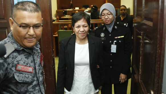 Australian Maria Elvira Pinto Exposto, center, leaves her hearing at the Shah Alam High Court after being found not guilty in Shah Alam, Malaysia, Wednesday, Dec. 27, 2017. Exposto has been acquitted  ...