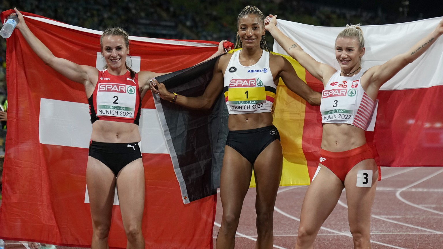 Bronze medalist Annik Kalin, of Switzerland, gold medalist Nafissatou Thiam, of Belgium, and silver medalist Adrianna Sulek, of Poland, from left to right, pose after finishing the Women&#039;s heptat ...