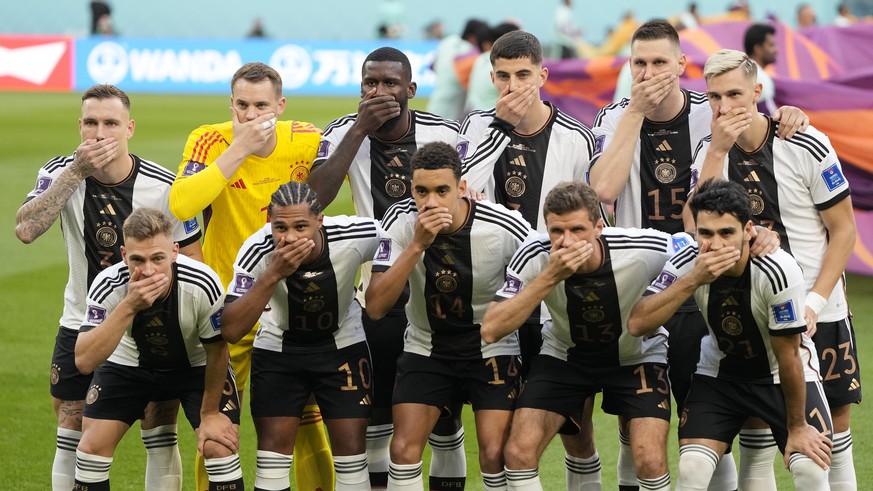German&#039;s team covers their mouth during the team photo prior to the World Cup group E soccer match between Germany and Japan, at the Khalifa International Stadium in Doha, Qatar, Wednesday, Nov.  ...
