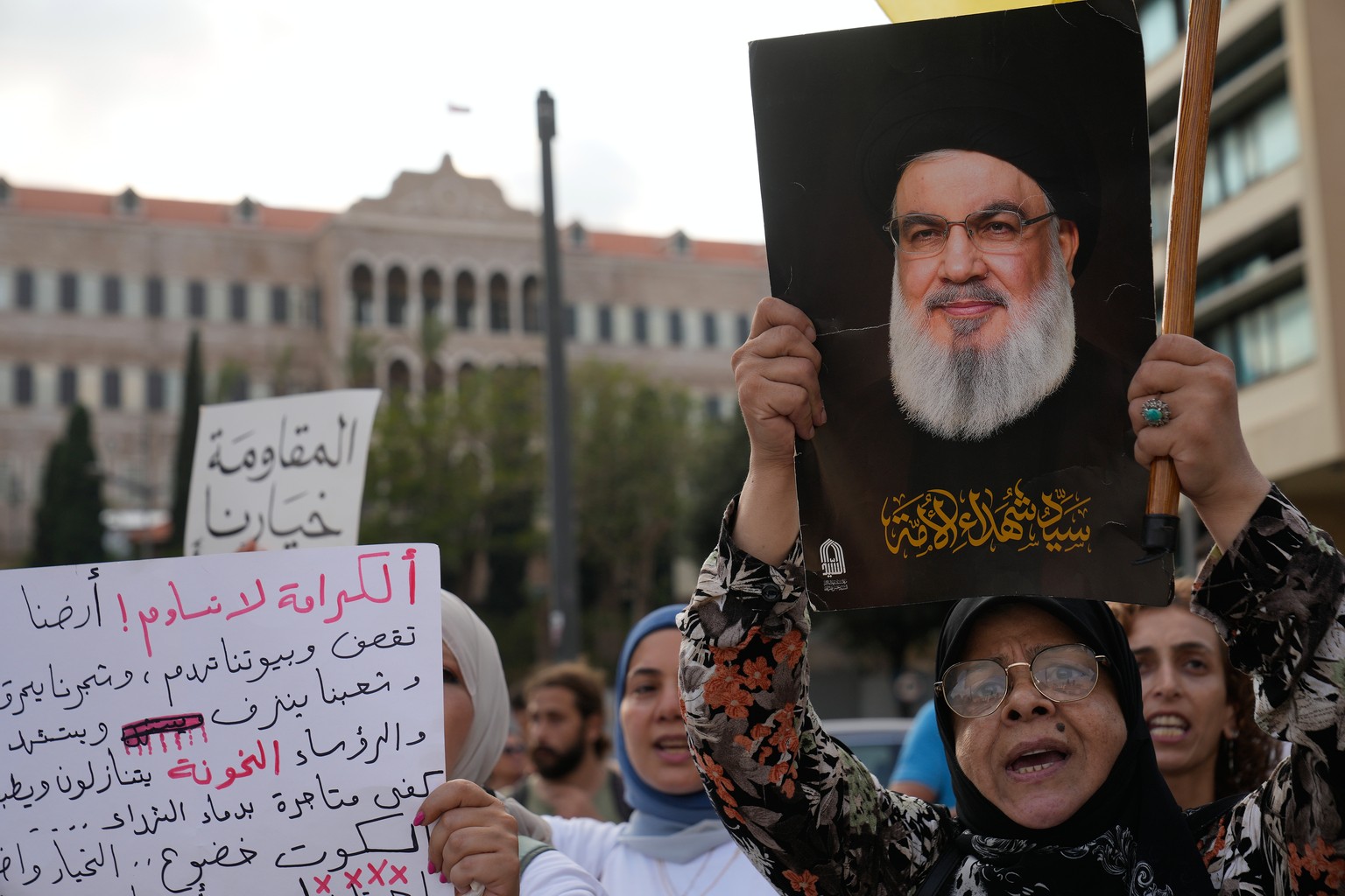 A protester shouts slogans while holding a portrait of the late Hezbollah leader Hassan Nasrallah during a protest against the backdrop of Lebanon-Israel talks and the normalization of relations, in B ...