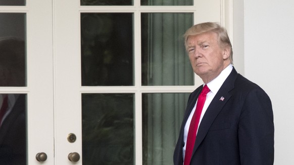 epa06015679 US President Donald J. Trump walks down the Colonnade to the Oval Office after returning to the White House by Marine One, in Washington, DC, USA, 07 June 2017. Trump returns from Cincinna ...