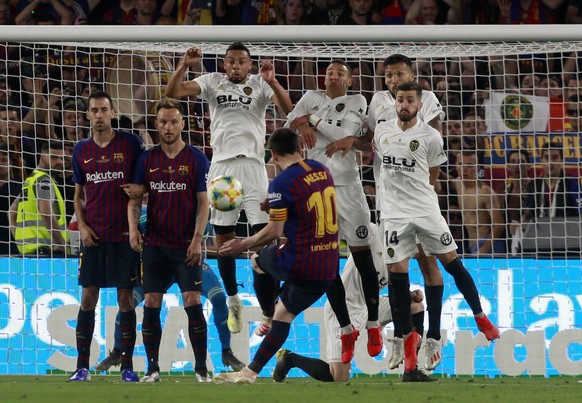 Barcelona forward Lionel Messi takes a free kick during the Copa del Rey soccer match final between Valencia CF and FC Barcelona at the Benito Villamarin stadium in Seville, Spain, Saturday. 25, 2019. ...