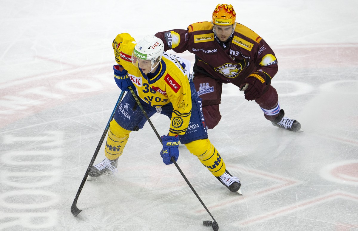 Davos' forward Simon Knak, left, vies for the puck with PostFinance Top Scorer Geneve-Servette's defender Henrik Toemmernes, of Sweden, right, during a National League regular season game of ...