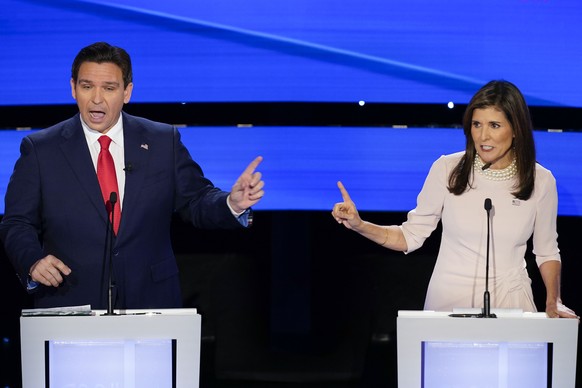 Former UN Ambassador Nikki Haley, right and Florida Gov. Ron DeSantis, left, pointing at each other during the CNN Republican presidential debate at Drake University in Des Moines, Iowa, Wednesday, Ja ...