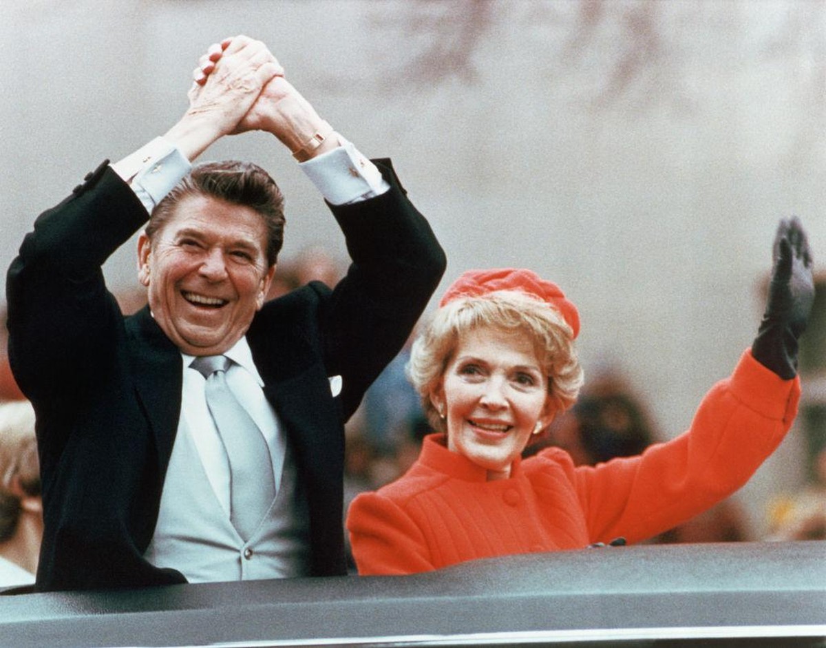 Ronald and Nancy Reagan waving and clasping hands in victory at Reagan's first inauguration, January 20, 1981. (Photo by © CORBIS/Corbis via Getty Images)