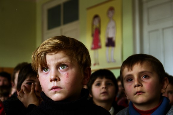 GEORGIA. Pankisi Gorge, a Chechen refugee settlement. January. 2008. Kindergarten. A boy with green eyes, Omaar, 7 years old. Omaar&#039;s family was bombed during the Chechen war while he was just a  ...