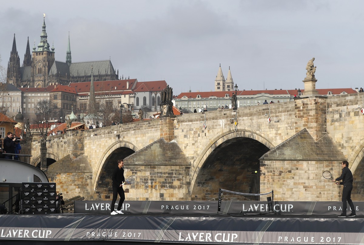 Switzerland's tennis player Roger Federer, right, returns a ball to Czech Republic's Tomas Berdych, left, during an exhibition match on Vltava river in Prague, Czech Republic, Monday, Feb. 2 ...