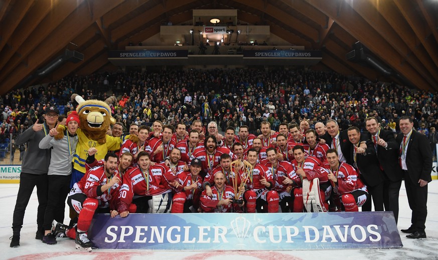 epa08096190 The players and the staff of Team Canada celebrate after winning the final game between Team Canada and HC Ocelari Trinec at the 93rd Spengler Cup ice hockey tournament in Davos, Switzerla ...