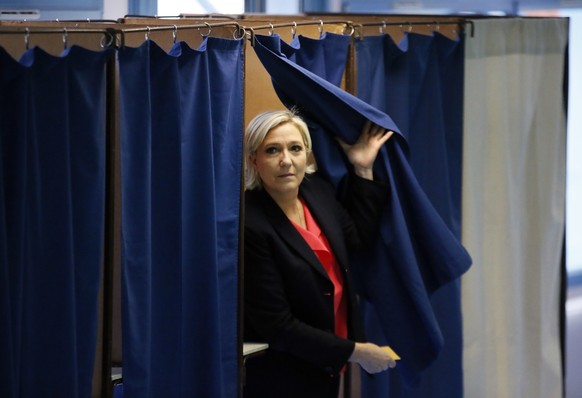 French far-right presidential candidate, Marine Le Pen exits a voting booth before casting her ballot in Henin Beaumont, France, Sunday, May 7, 2017. Voters across France are choosing a new president  ...