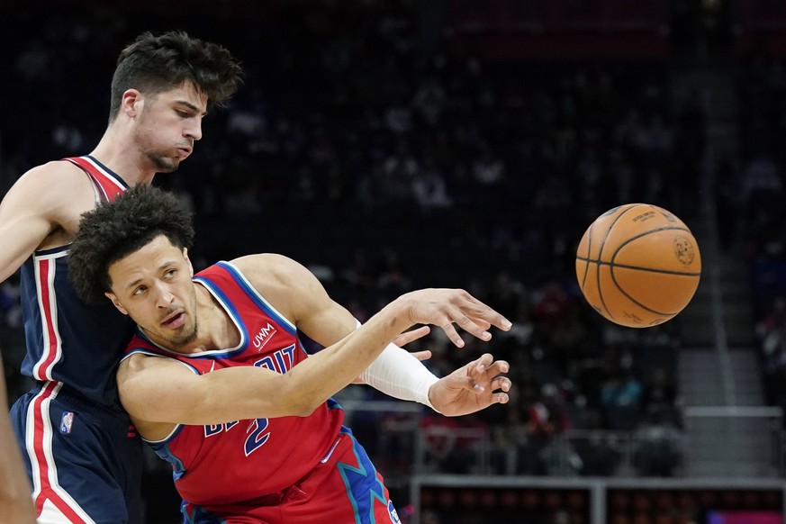 Detroit Pistons guard Cade Cunningham (2) passes as Washington Wizards forward Deni Avdija defends during the first half of an NBA basketball game, Friday, March 25, 2022, in Detroit. (AP Photo/Carlos ...