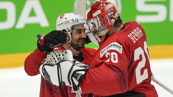 Switzerland&#039;s keeper Reto Berra is celebrated by Switzerland&#039;s Andres Ambuhl, left, after winning the penalty shootout of the group A Hockey World Championship match between Germany and Swit ...