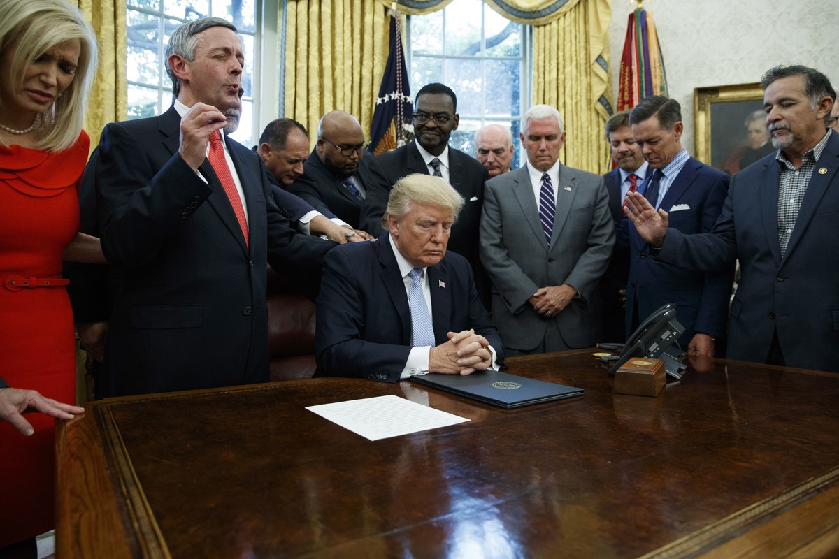FILE - Religious leaders pray with President Donald Trump Sept. 1, 2017, after he signed a proclamation for a national day of prayer to occur on Sept. 3, 2017, in the Oval Office of the White House in ...