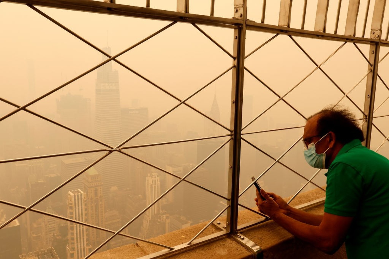 NEW YORK, NY - JUNE 7: Heavy smoke fills the air shrouding the view to the northeast to One Vanderbilt and the Chrysler Building from the 86th floor of the Empire State Building as a person tries to t ...
