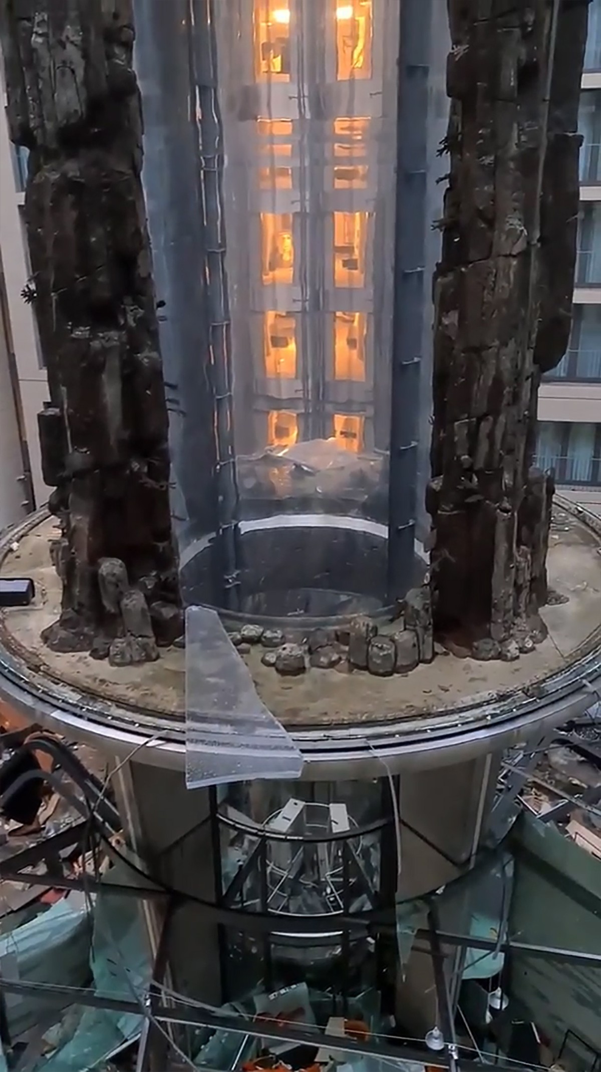epa10368785 A still image obtained from a social media video shows the AquaDom aquarium after it burst, in Berlin, Germany, 16 December 2022. A 14-meter aquarium has burst at a hotel in downtown Berli ...