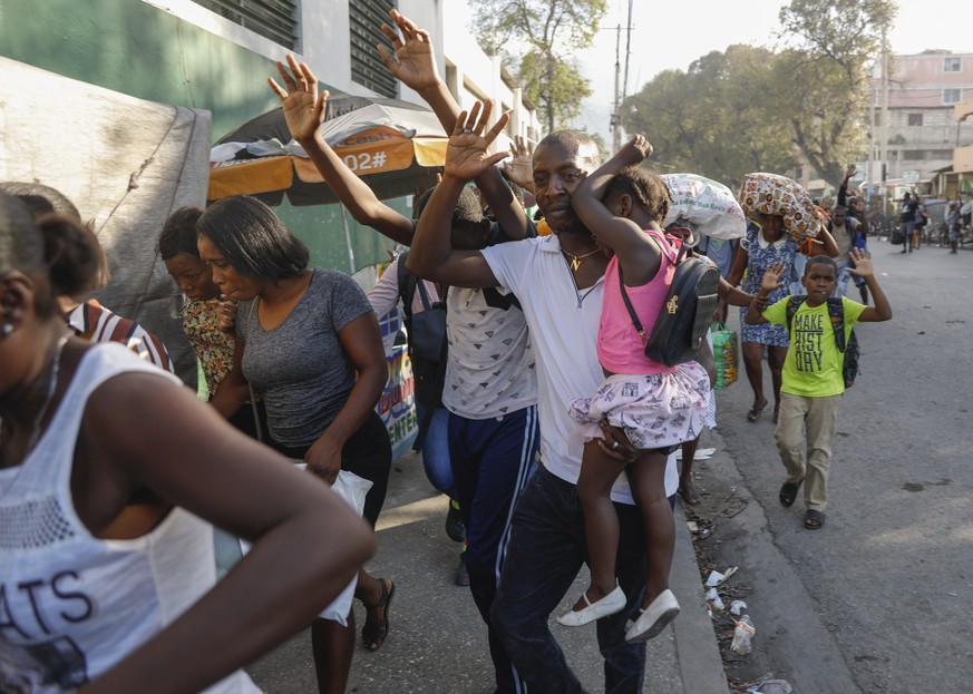 FILE - Residents flee their homes during clashes between police and gang member at the Portail neighborhood in Port-au-Prince, Haiti, Thursday, Feb. 29, 2024. Unrelenting gang attacks in Haiti have pa ...
