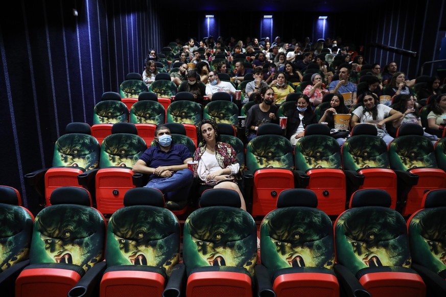 epa09231901 People attend a movie at Cinema City in Jerusalem, Israel, 27 May 2021. Israel officially reopens cinemas after more than a year of closure following a successful vaccination campaign agai ...