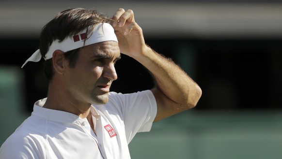 Switzerland&#039;s Roger Federer adjusts his headband during his men&#039;s singles match against Germany&#039;s Jan-Lennard Struff, on the fifth day of the Wimbledon Tennis Championships in London, F ...