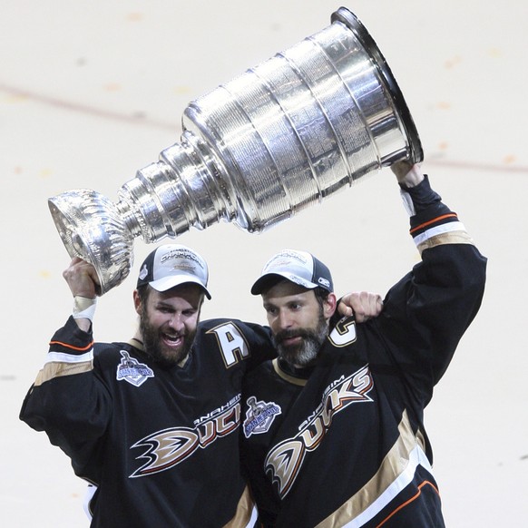 Anaheim Ducks Scott Niedermayer, right, and his brother Rob hoist the Stanley Cup after the Ducks defeated the Ottawa Senators, 6-2, in Game 5 of Stanley Cup hockey finals in Anaheim, Calif., Wednesda ...