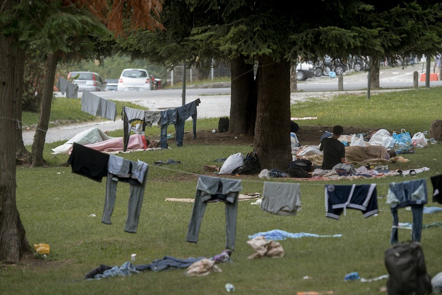 Fluechtlinge haben sich in einem Park wenige hundert Meter vom Bahnhof Como in Italien in einem Park niedergelassen am Freitag, 22. Juni 2016. An einer Leine trocknen sie Kleider, die von den naechtli ...