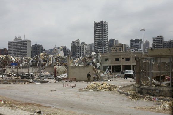 A soldier stands at the devastated site of the explosion at the port of Beirut, Lebanon, Thursday Aug.6, 2020. French President Emmanuel Macron has arrived in Beirut to offer French support to Lebanon ...