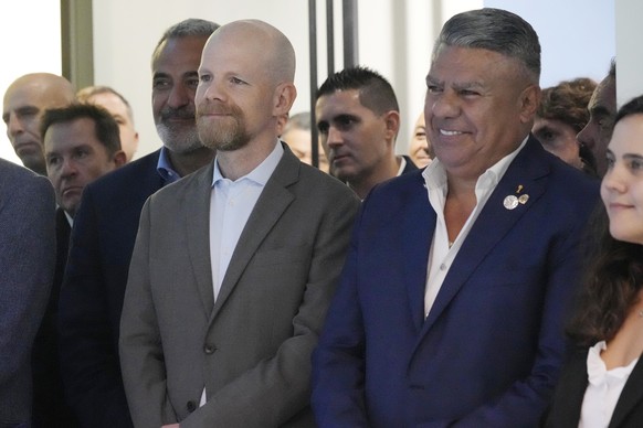 AFA President Claudio &quot;Chiqui&quot; Tapia, left, and FIFA Secretary General Mattias Grafstrom listen to remarks during a ceremonial opening of the U.S. headquarters of the Argentina Football Asso ...