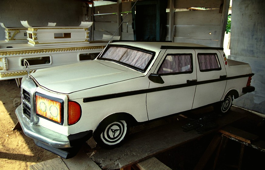Coffin in the shape of a Mercedes Benz car. The fantasy coffins of Teshie-Nungua. Among the Ga people, those of nobility and wealth often choose to be buried in whimsical coffins made in the form of a ...