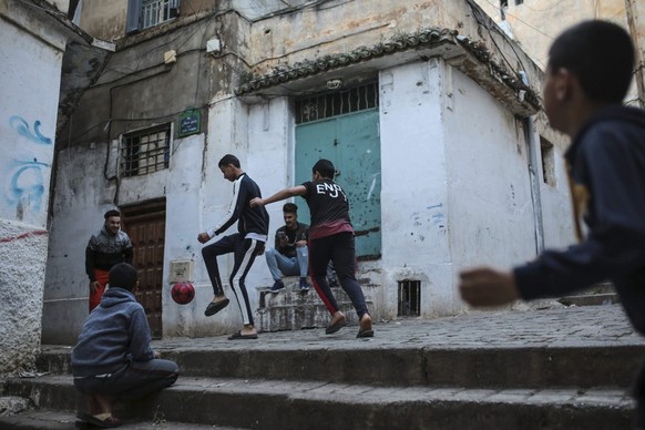 FILE - Children play football in Kasbah of Algiers, a UNESCO world heritage site, Algeria, April 11, 2019. Visa applicants from Africa who want to visit Europe's Schengen Area face far higher rej ...