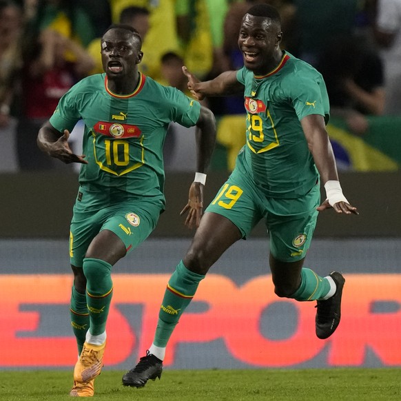 Senegal&#039;s Sadio Mane, centre, celebrates after scoring his side&#039;s third goal during the international friendly soccer match between Brazil and Senegal, at the Alvalade Stadium in Lisbon, Por ...