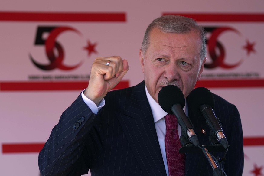 Turkish President Recep Tayyip Erdogan talks during a military parade, in the Turkish occupied area of the divided capital Nicosia, Cyprus, Saturday, July 20, 2024. (AP Photo/Petros Karadjias)