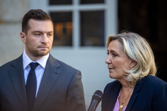 epa12064512 President of the far-right Rassemblement National (RN) parliamentary group, Marine Le Pen (R), and RN President Jordan Bardella (L) speak to the media after a meeting with the French prime ...