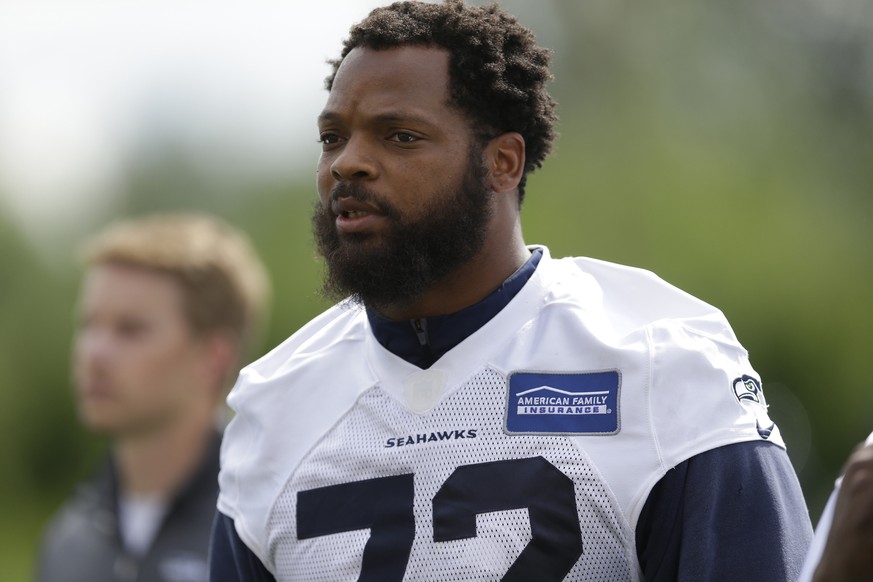 FILE - In this June 13, 2017, file photo, Seattle Seahawks defensive end Michael Bennett walks off the field following NFL football practice in Renton, Wash. Bennett said he will sit during the nation ...