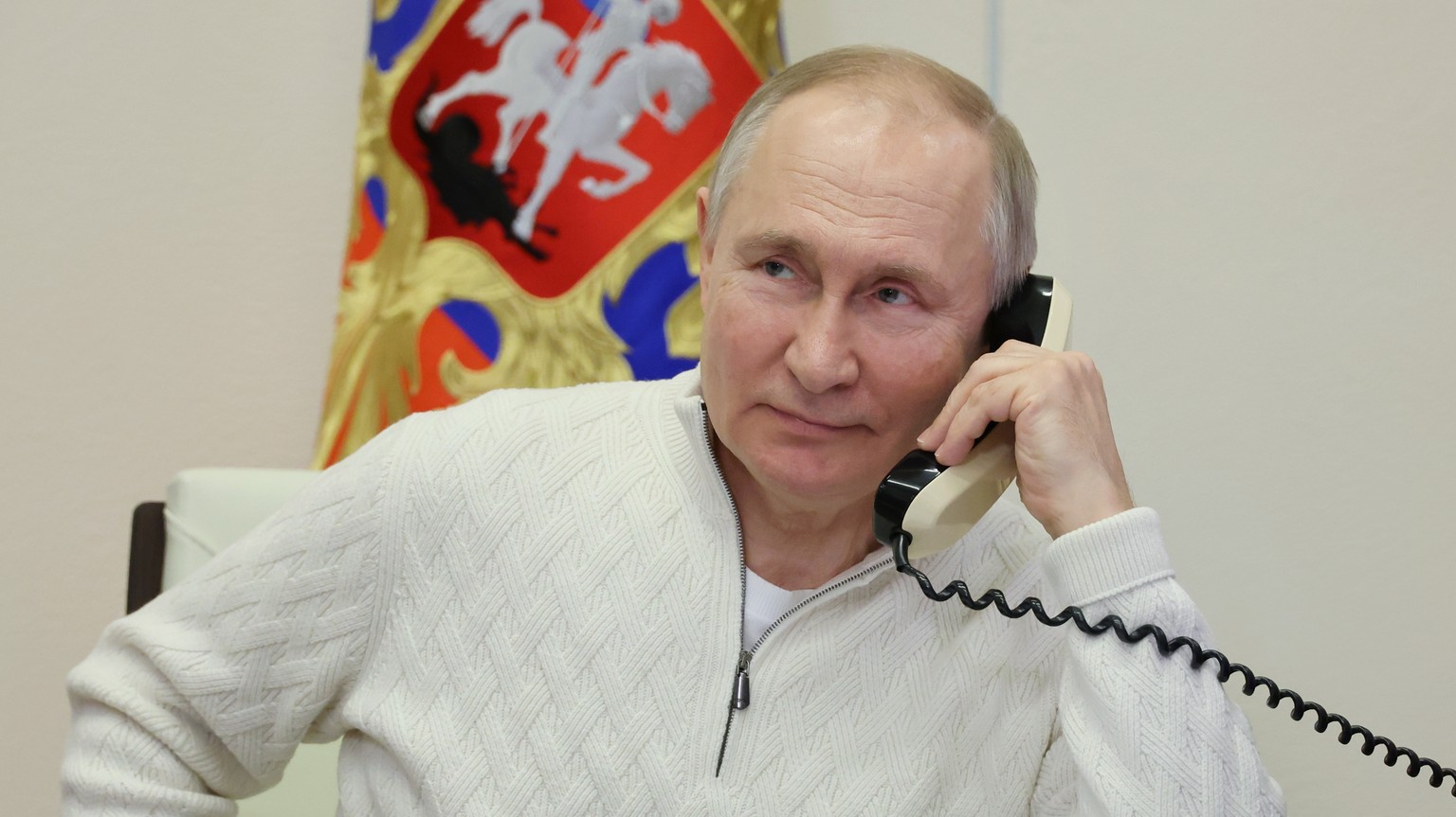 epa10391044 Russian President Vladimir Putin speaks on the phone to seven-year-old David Shmelev from Stavropol Krai region, who took part in the New Year Tree of Wishes nationwide charity campaign, a ...