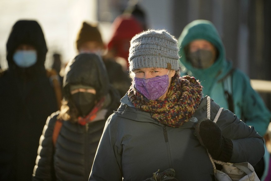 Commuters brave the single digit temperatures Fahrenheit as they arrive on a ferry, Tuesday, Jan. 11, 2022, in Portland, Maine. A mass of arctic air swept into the Northeast, bringing bone-chilling su ...