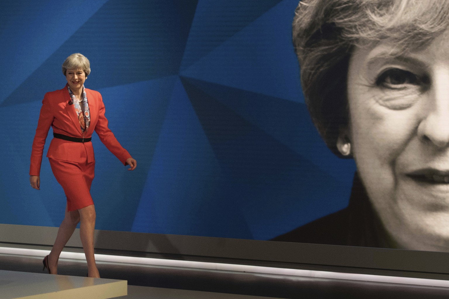 British Prime Minister Theresa May walks out to take part in a general election broadcast, in London, Monday May 29, 2017. ﻿Prime Minister Theresa May and Labour Party leader Jeremy Corbyn will face a ...