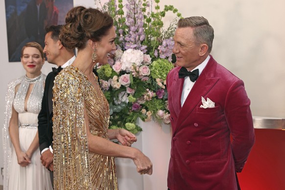 Britain&#039;s Kate, the Duchess of Cambridge, left, speaks to British actor Daniel Craig up arrival for the World premiere of the new film from the James Bond franchise &#039;No Time To Die&#039;, in ...