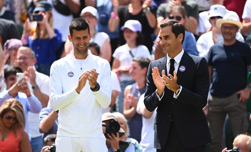 epa10049482 Novak Djokovic (L) of Serbia and Roger Federer (R) of Switzerland attend an event to celebrate the 100th anniversary of the Centre Court ahead of the women&#039;s 4th round match between H ...