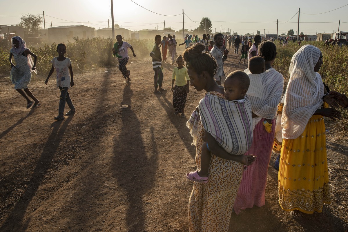 Tigray refugees who fled a conflict in the Ethiopia's Tigray region, run at Village 8, the transit centre near the Lugdi border crossing, eastern Sudan, Sunday, Nov. 22, 2020. Ethiopia's mil ...